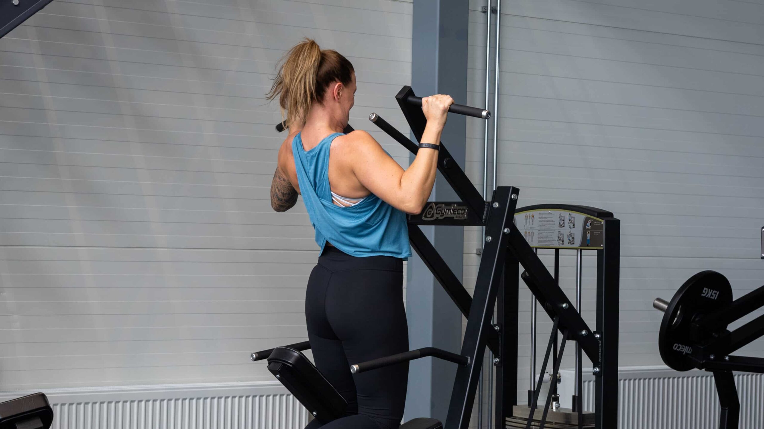Women working out chins in Gymleco's chins / dips combi gym machine